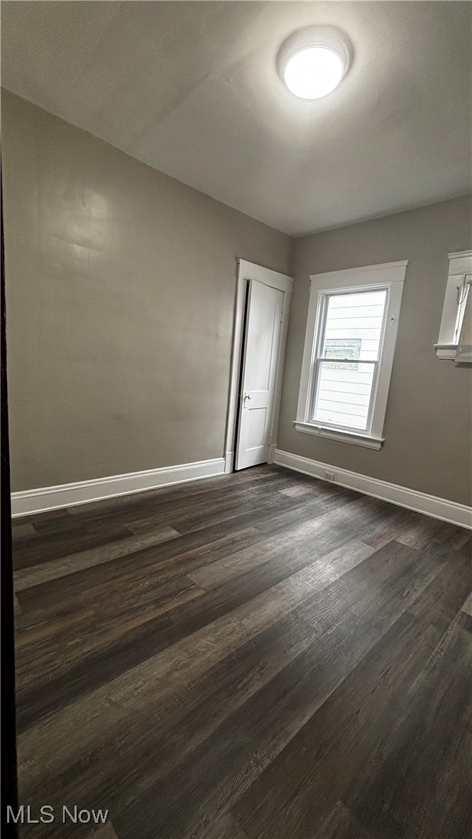 13421 Ashburton Road Cleveland, OH 44110 - Photo 8 of 28 Empty room with dark hardwood / wood-style floors