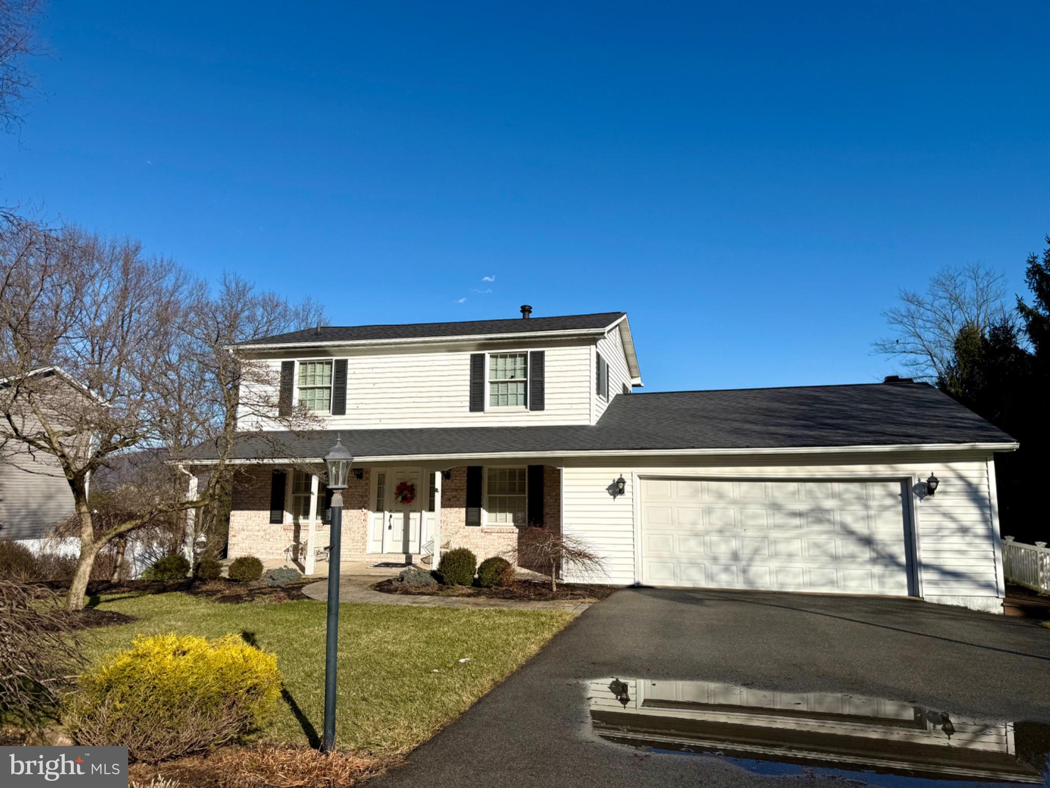 Charming two-story home under blue skies.