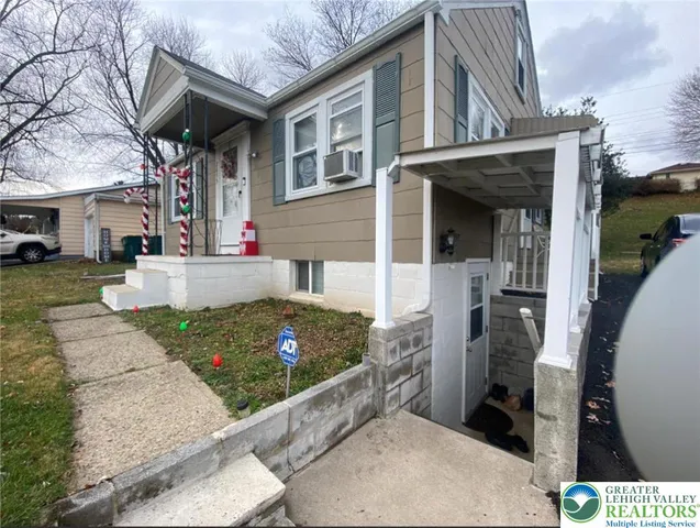 a view of a house with brick walls and a yard