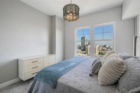 a bedroom with a bed and window