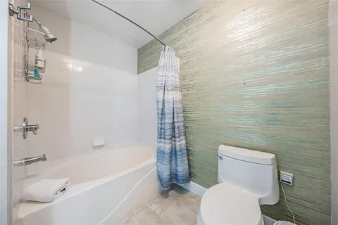 a bathroom with a toilet and shower