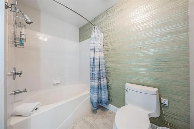 a bathroom with a toilet and shower
