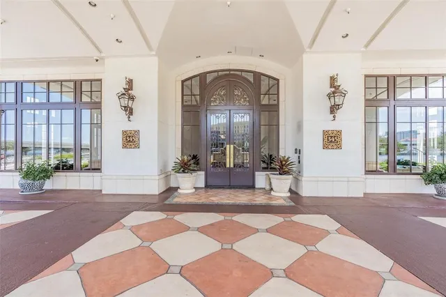 a living room with a black white checkered floor next to a large window