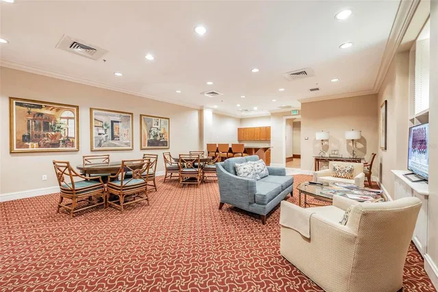 a living room with furniture kitchen view and a table
