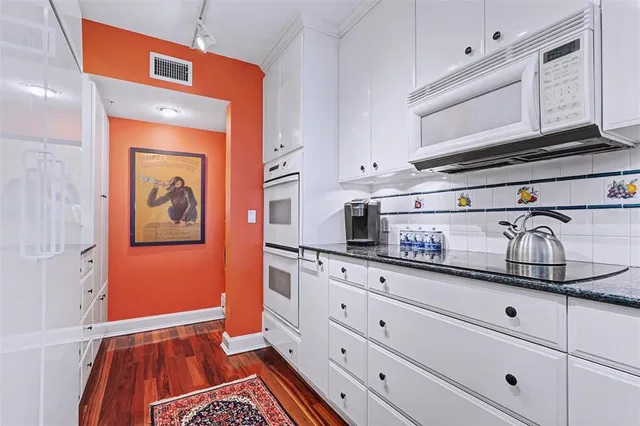 a kitchen with stainless steel appliances granite countertop a sink and cabinets