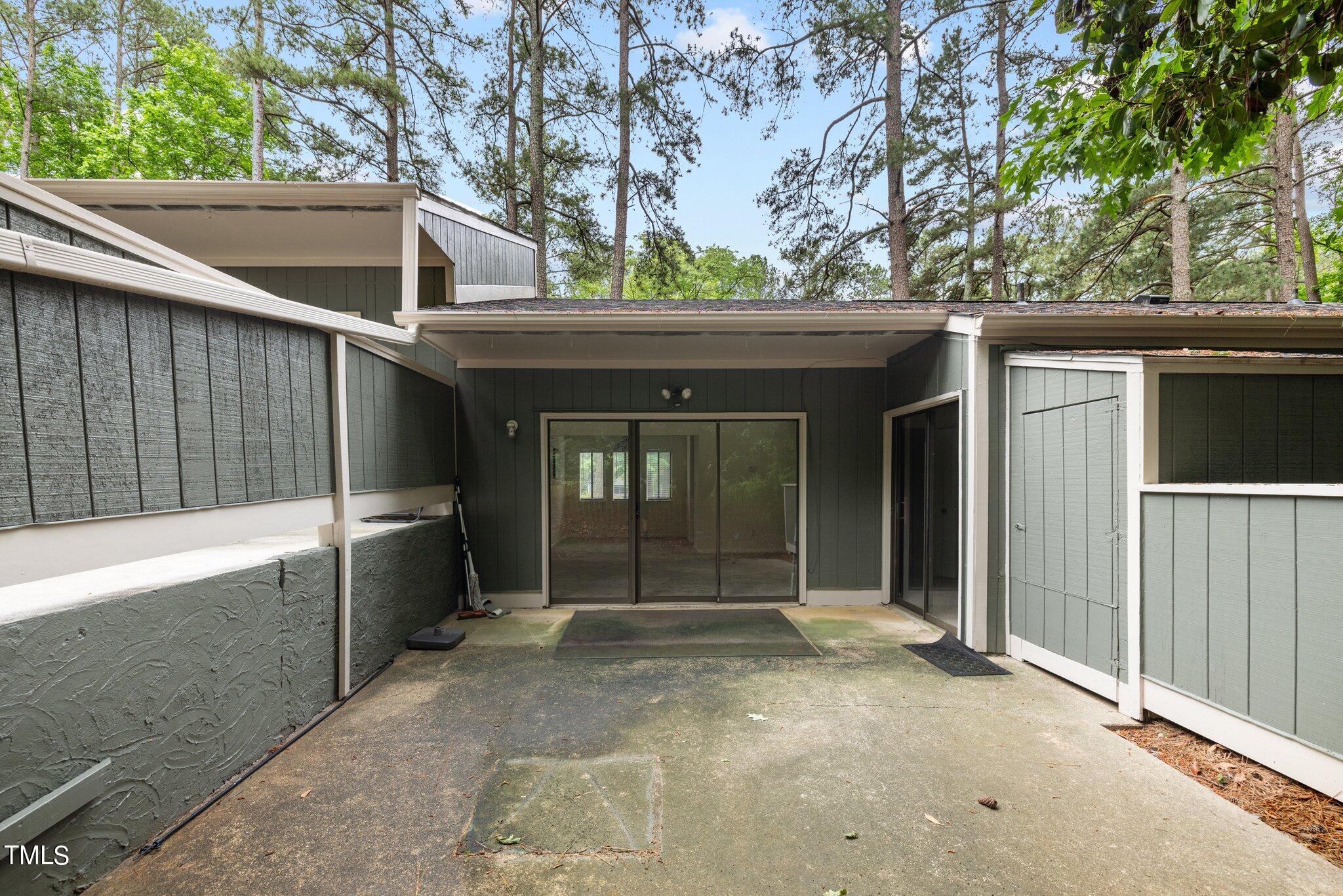 708 Godwin Court Raleigh, NC 27606 - Photo 12 of 48 a view of a house with a large window and wooden fence