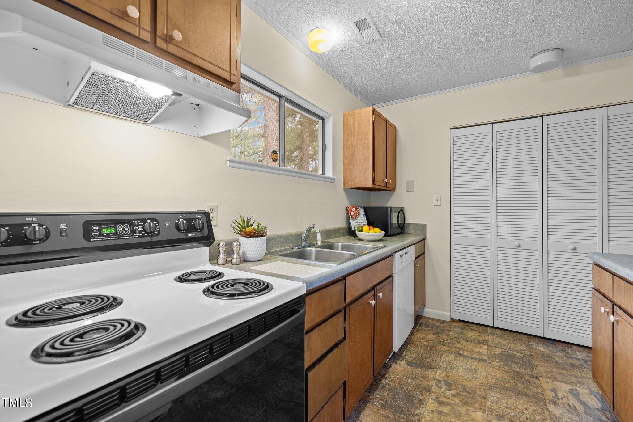 708 Godwin Court Raleigh, NC 27606 - Photo 18 of 48 a kitchen with a stove and a sink