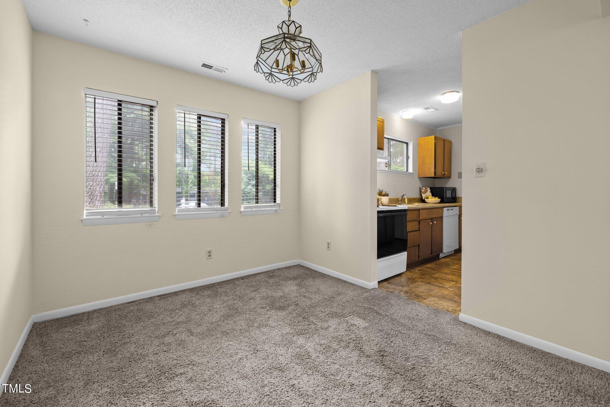 708 Godwin Court Raleigh, NC 27606 - Photo 20 of 48 an empty room with windows and cabinet
