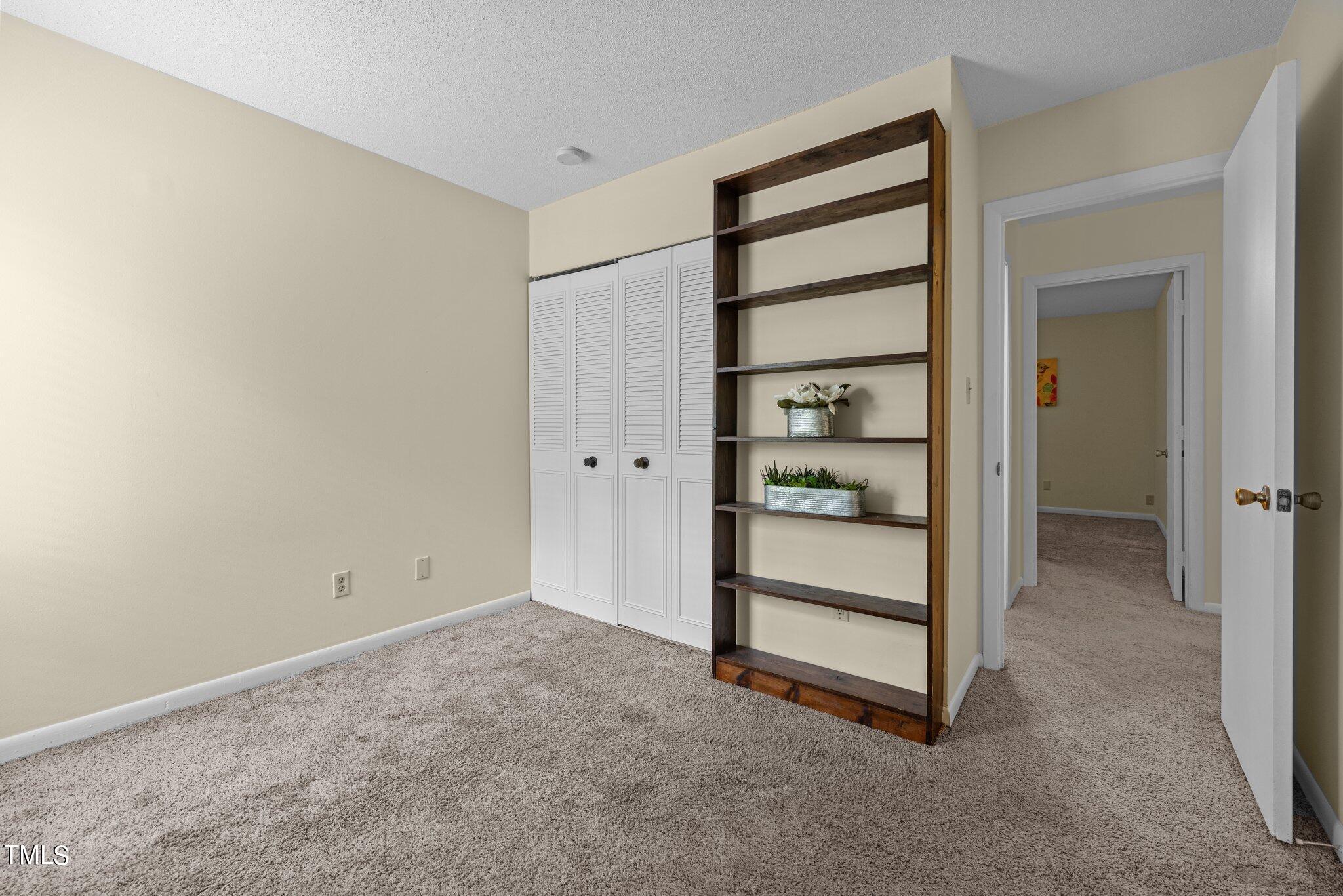 708 Godwin Court Raleigh, NC 27606 - Photo 27 of 48 a view of an empty room with cabinet and a window