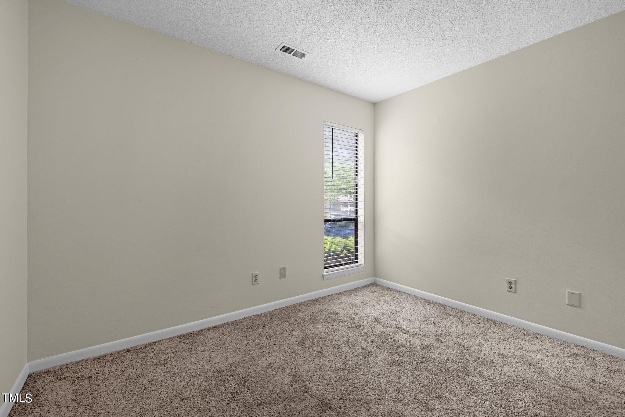 708 Godwin Court Raleigh, NC 27606 - Photo 28 of 48 a view of an empty room with a window