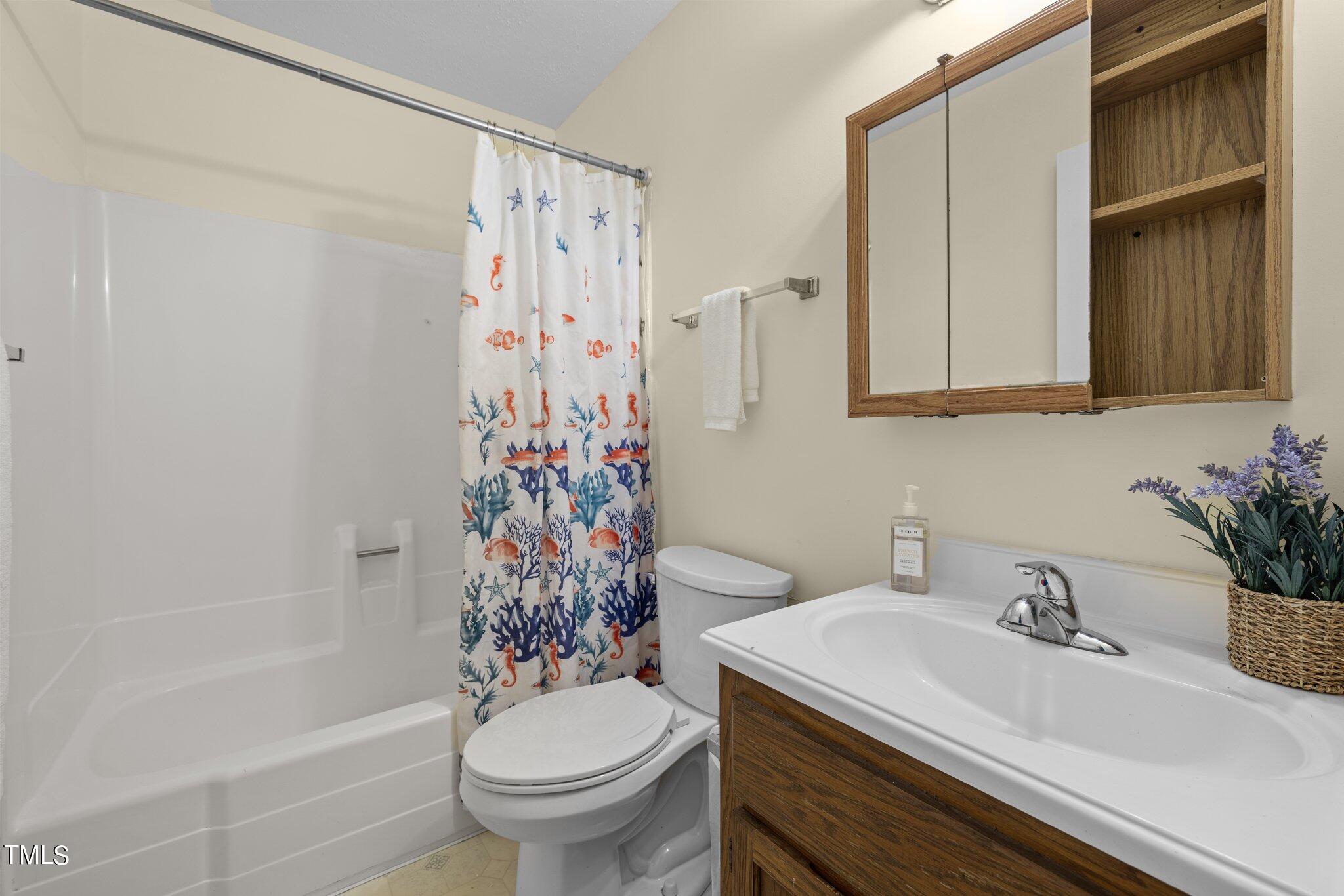 708 Godwin Court Raleigh, NC 27606 - Photo 29 of 48 a bathroom with a sink toilet and shower