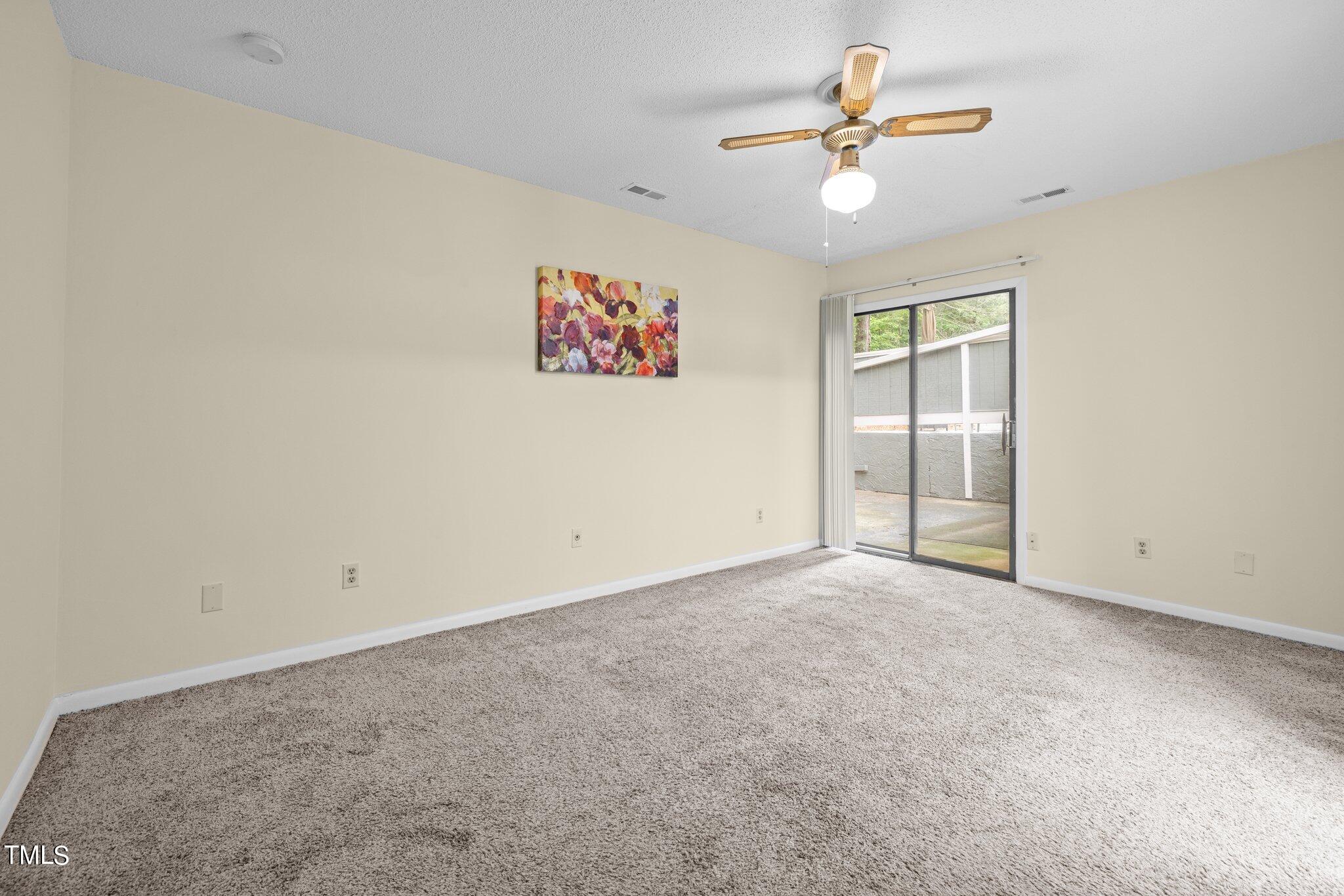 708 Godwin Court Raleigh, NC 27606 - Photo 36 of 48 an empty room with closet and a ceiling fan