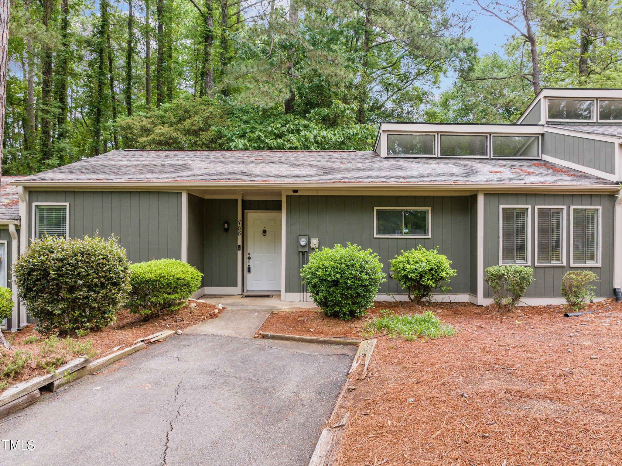 708 Godwin Court Raleigh, NC 27606 - Photo 4 of 48 a front view of a house with garden and porch
