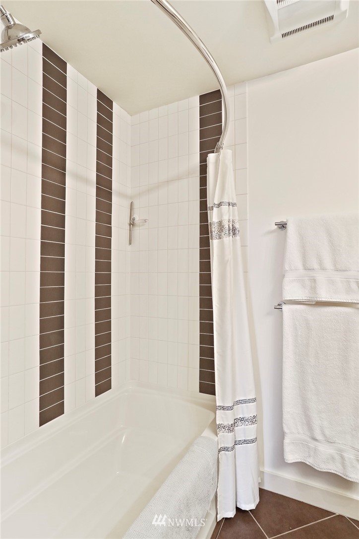 910 Lenora Street, Unit S1203 Seattle, WA 98121 - Photo 20 of 39 a bathroom with a bathtub and shower