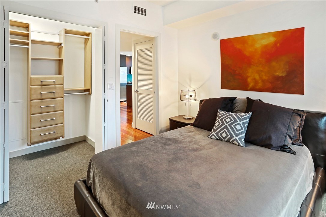910 Lenora Street, Unit S1203 Seattle, WA 98121 - Photo 21 of 39 a bedroom with a bed and cabinet