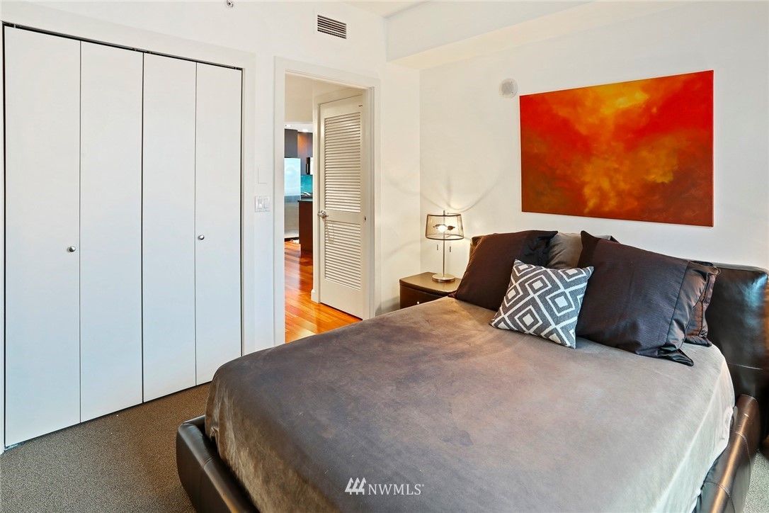 910 Lenora Street, Unit S1203 Seattle, WA 98121 - Photo 22 of 39 a bedroom with a bed and cupboard