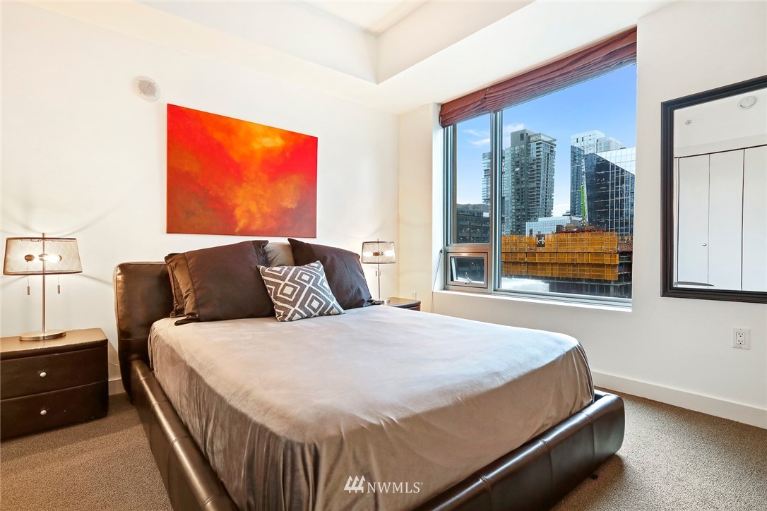910 Lenora Street, Unit S1203 Seattle, WA 98121 - Photo 23 of 39 a bed sitting in a bedroom next to a window