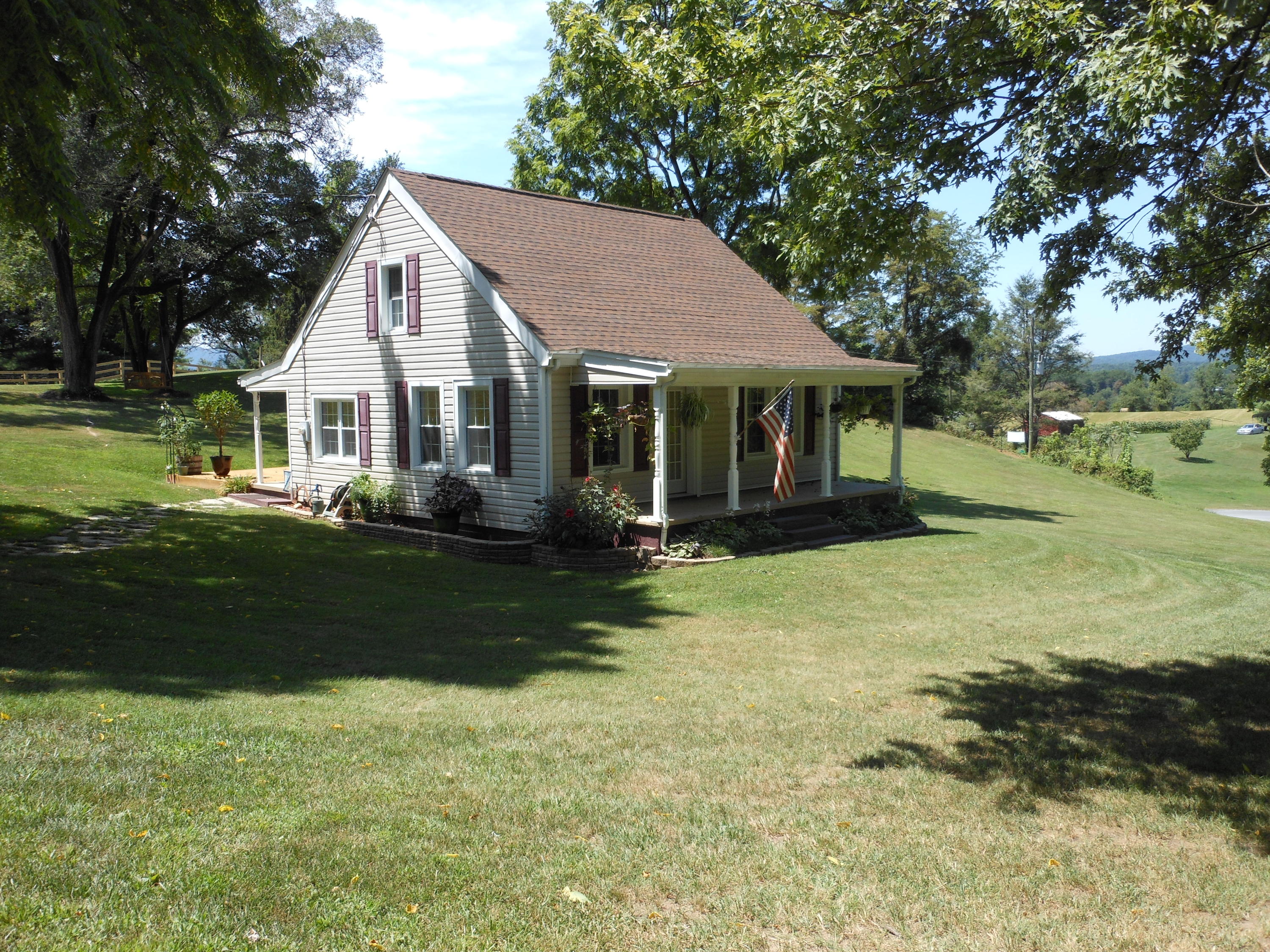 334 Zimmerman Road Blue Ridge, VA 24064 - Photo 1 of 1 a front view of a house with a garden and trees