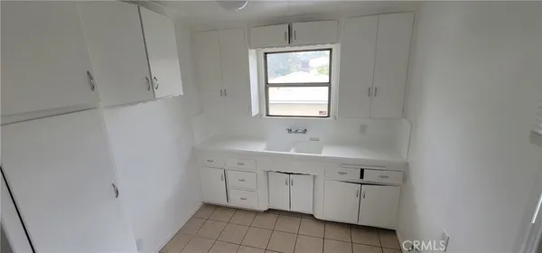 a bathroom with a sink vanity and tub