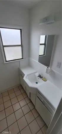 a bathroom with a sink and a window