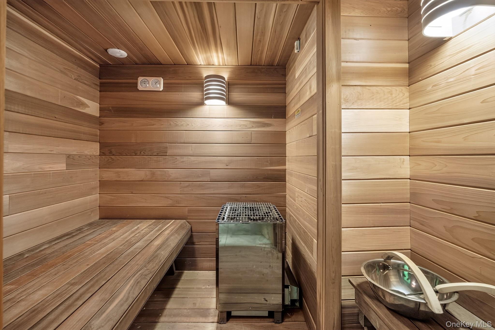 23 Inningwood Road Ossining, NY 10562 - Photo 32 of 50 Sauna room featuring full wood-paneling, built-in wooden benches, and a wall-mounted heater unit