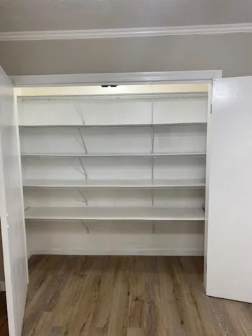 a view of a room with a wooden floor