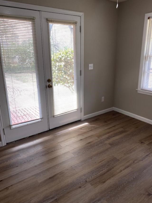 7215 Mobley Road Columbus, GA 31904 - Photo 9 of 16 a view of an empty room with wooden floor and a window