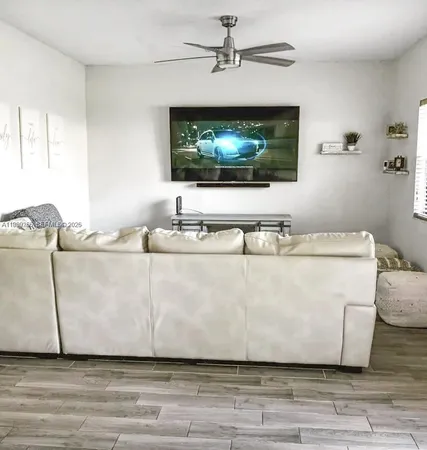 a living room with furniture and a flat screen tv