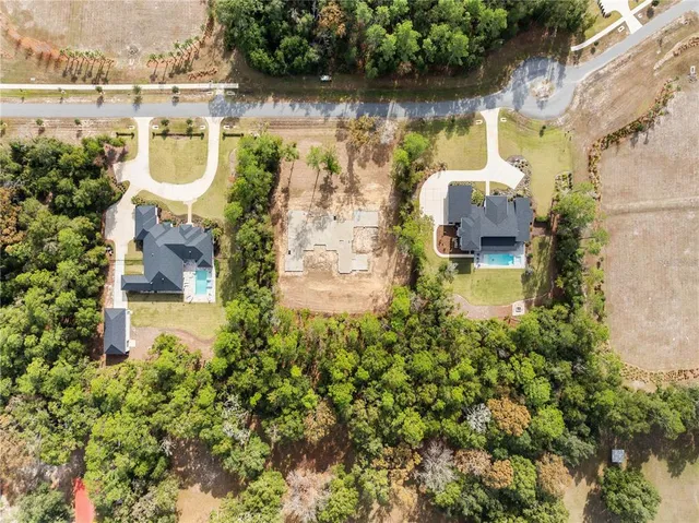 an aerial view of a house with outdoor space and lake view