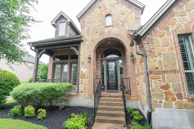 a view of small house with potted plants