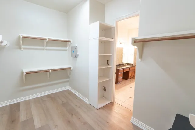 a view of walk in closet with empty racks
