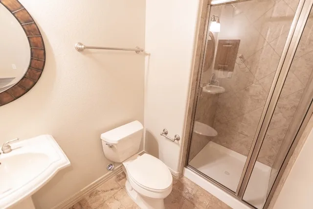 a white toilet sitting next to a bathroom sink