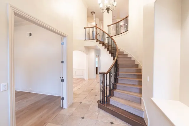 a view of entryway and gallery with wooden floor