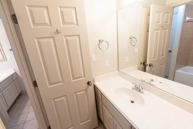a bathroom with a sink a mirror and a shower