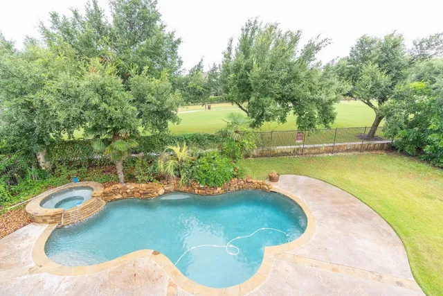 a view of a swimming pool with a yard