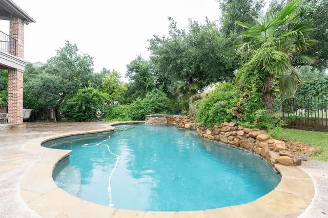 a view of a swimming pool with a yard