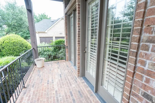 a view of balcony with floor to ceiling windows and wooden fence