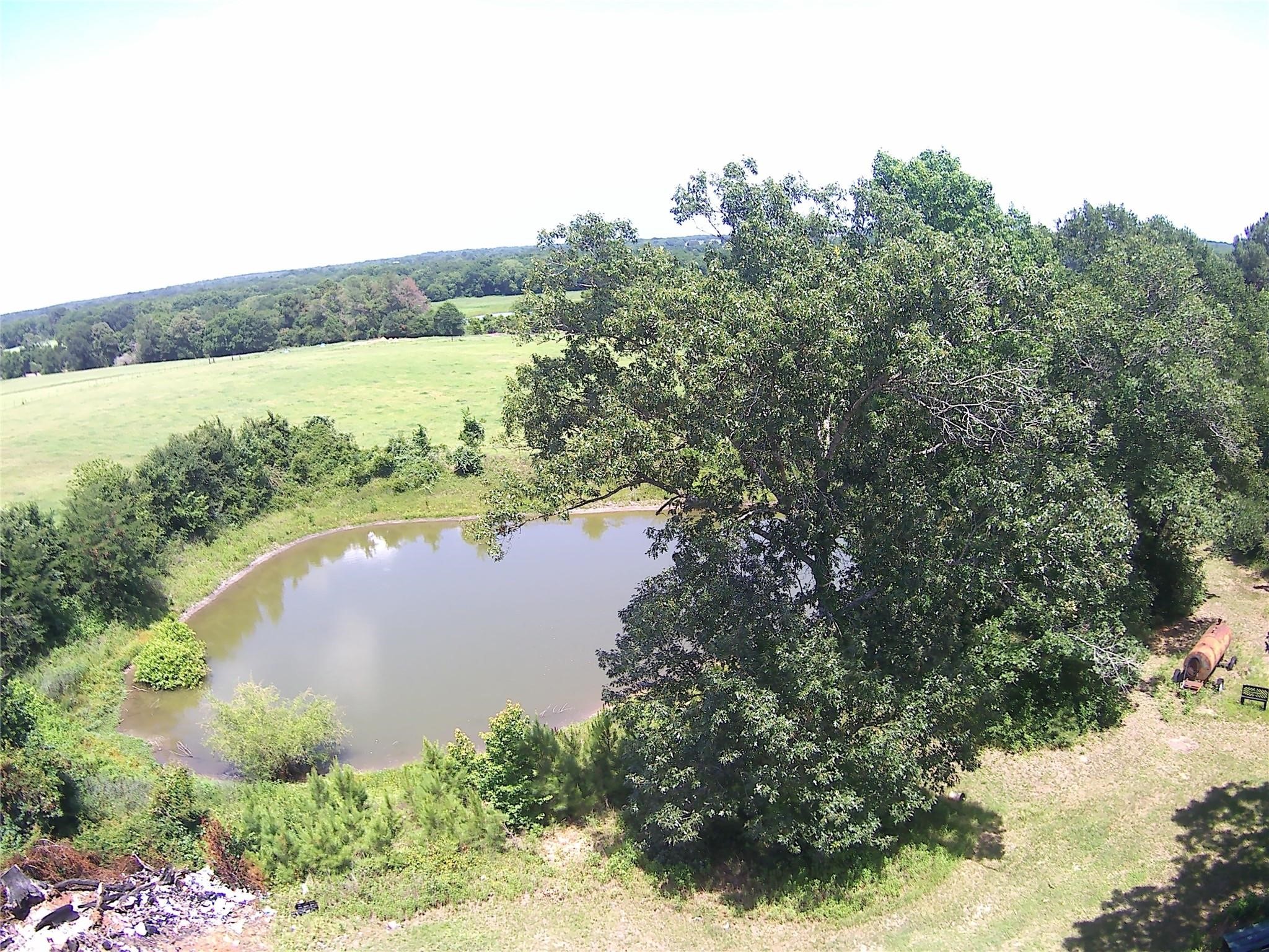2264 North Fm 1486 Road Montgomery, TX 77356 - Photo 6 of 6 a view of a lake with a yard and mountain in the back