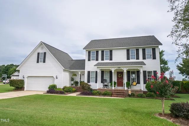 a front view of a house with a garden and porch