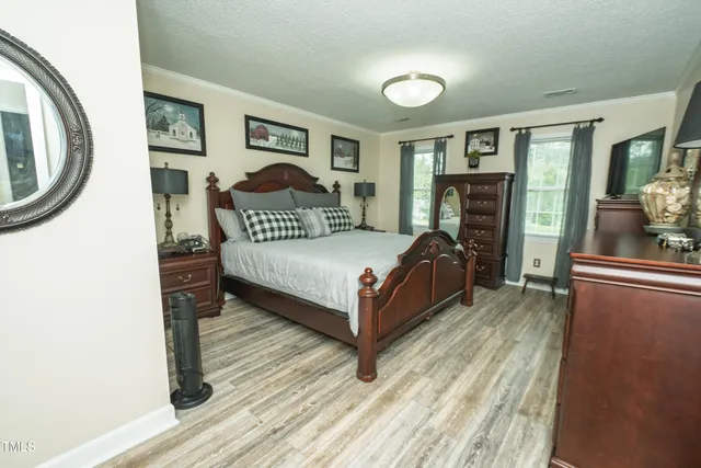 a bedroom with a bed lamp closet and large window