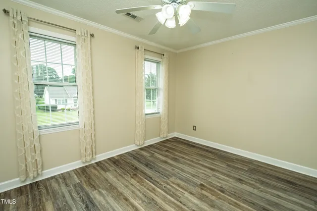 wooden floor in an empty room with a window