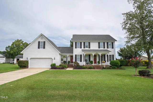 a front view of house with yard and green space
