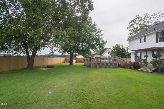 a view of a house with a yard and tree