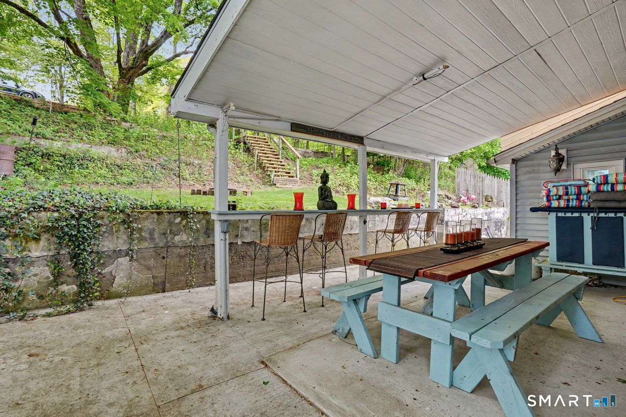 74 Maple Street Seymour, CT 06483 - Photo 17 of 40 a view of a patio with a table chairs and a backyard