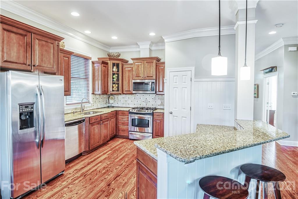 700 Revival Row Fort Mill, SC 29708 - Photo 8 of 44 a kitchen with stainless steel appliances granite countertop a sink refrigerator and cabinets