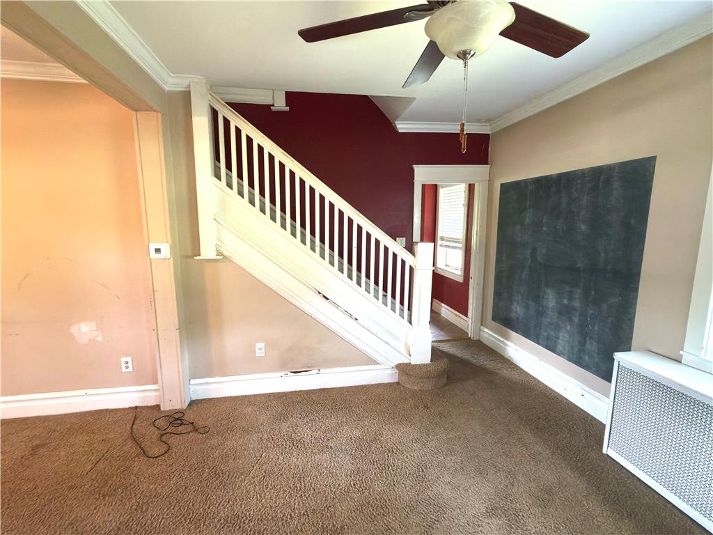 4550 Vera Cruz Road Center Valley, PA 18034 - Photo 19 of 43 Classical staircase with white trim anchors the carpeted living area.