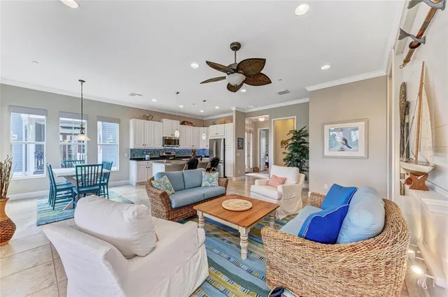 a large kitchen with granite countertop lots of white cabinets appliances and furniture