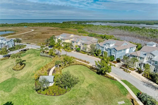 an aerial view of residential houses with outdoor space and swimming pool