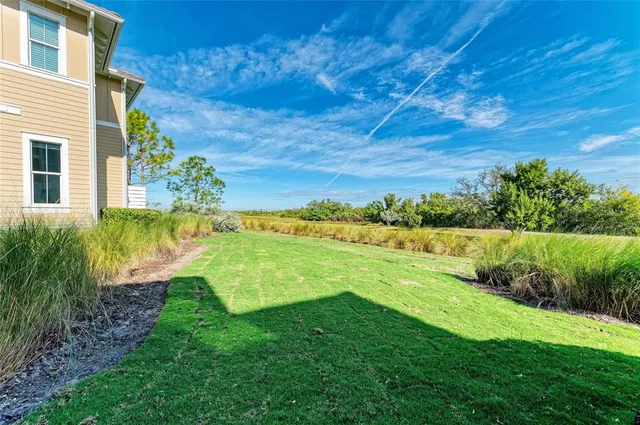 a view of a house with wooden stairs and flowers