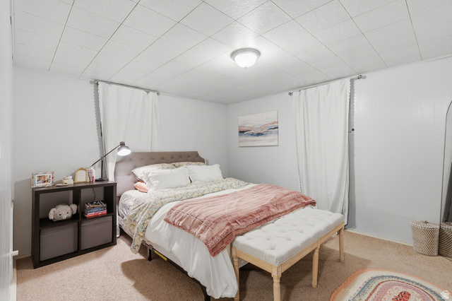 85 North 800 West Provo, UT 84601 - Photo 20 of 25 Carpeted bedroom featuring light-toned walls and a grid-patterned ceiling